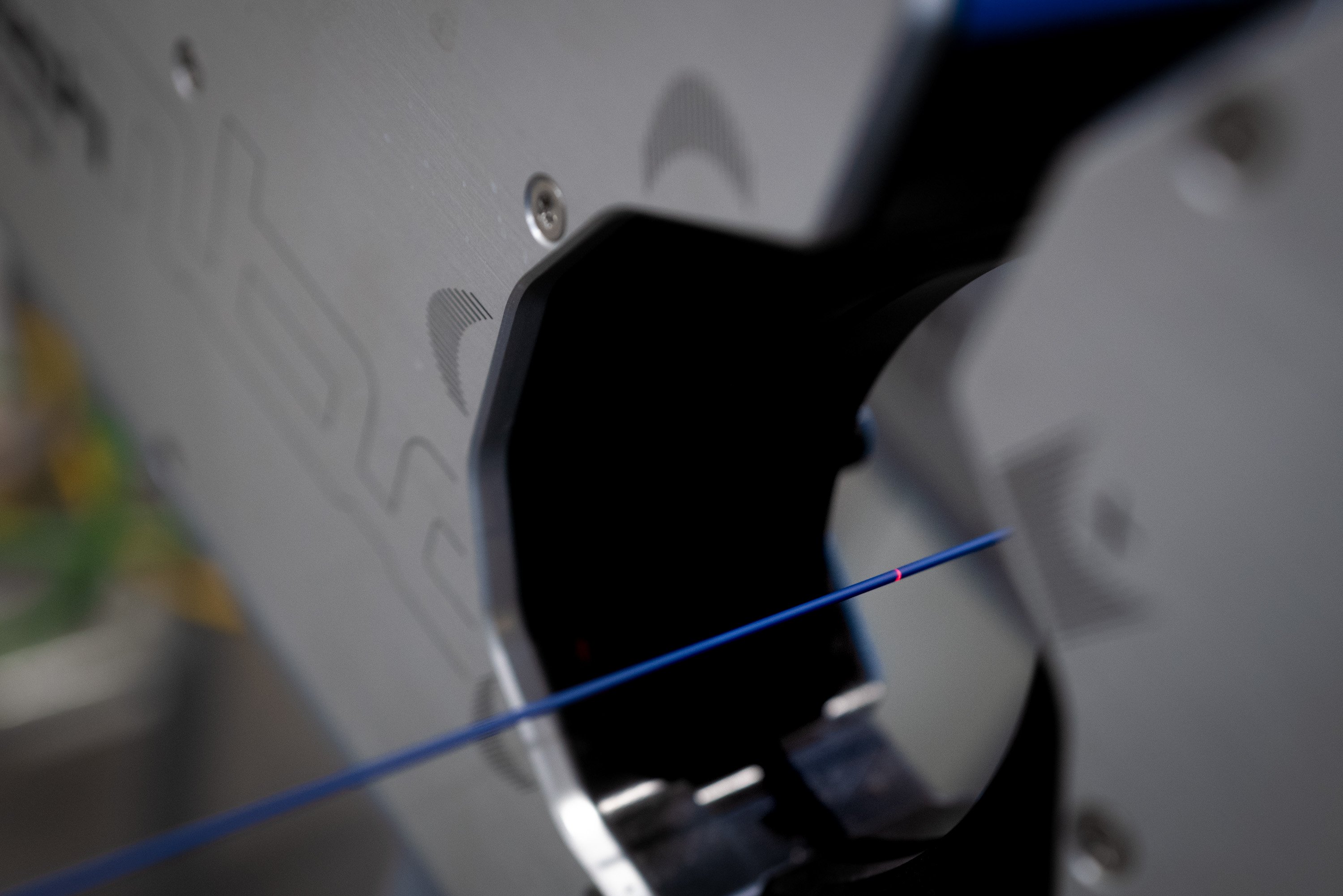 Fiber optic cable being fed through precision machinery.